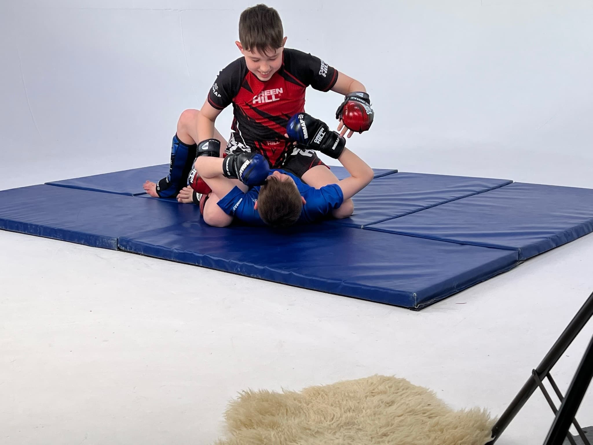 Junior MMA athletes training ground-and-pound at Iron Fight Club
