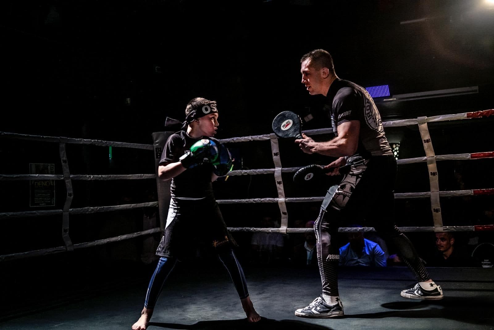 Coach Piotr on the pads with a young IFC fighter